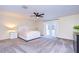 Main bedroom with plush carpet, a ceiling fan, and access to a balcony at 208 Elm View Ct, Brandon, FL 33511