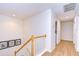 Upstairs hallway with light wood flooring and access to bedrooms at 208 Elm View Ct, Brandon, FL 33511