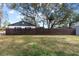 Large backyard with privacy fence and mature trees at 210 W Floriland Ave, Tampa, FL 33612