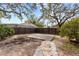 Large backyard with a wooden deck and stone pathway at 210 W Floriland Ave, Tampa, FL 33612