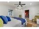 Bright bedroom with wood floors, ceiling fan, and window coverings at 210 W Floriland Ave, Tampa, FL 33612