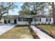 Front view of the renovated house with walkway and driveway at 210 W Floriland Ave, Tampa, FL 33612