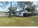 Side view of the house showcasing landscaping and fence at 210 W Floriland Ave, Tampa, FL 33612