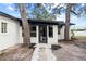 White house with black accents, new landscaping, and a spacious yard at 210 W Floriland Ave, Tampa, FL 33612