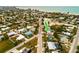 Aerial view showcasing a teal house's location near the beach amongst other houses at 214 85Th St, Holmes Beach, FL 34217