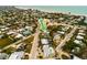 An aerial view of a teal home near the beach, showing its location in a residential area at 214 85Th St, Holmes Beach, FL 34217