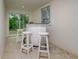 Basement bar with white stools and access to backyard at 214 85Th St, Holmes Beach, FL 34217