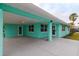 Mint green house exterior with covered patio and landscaping at 214 85Th St, Holmes Beach, FL 34217