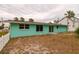 Back of house showing sliding glass doors and yard access at 214 85Th St, Holmes Beach, FL 34217