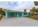 Front view of charming mint green house with driveway at 214 85Th St, Holmes Beach, FL 34217