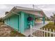 Side view of house with covered patio and AC unit at 214 85Th St, Holmes Beach, FL 34217