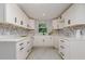 Renovated kitchen featuring white shaker cabinets, quartz countertops, and marble backsplash at 214 85Th St, Holmes Beach, FL 34217