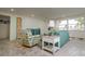 Cozy living room features a teal sofa and beach-themed armchairs at 214 85Th St, Holmes Beach, FL 34217