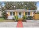 Charming white cottage with teal door, wood accents, and landscaped yard at 2242 22Nd S Ave, St Petersburg, FL 33712