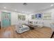 Light and airy living room with hardwood floors and a teal door at 2242 22Nd S Ave, St Petersburg, FL 33712