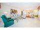 Bright living room with gray sofa, green armchair, and dining area at 2363 Israeli Dr # 25, Clearwater, FL 33763