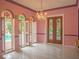 Pink dining room with stained glass windows and access to the pool at 263 Overbrook E St, Largo, FL 33770