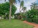 Landscaped front yard with lush tropical plants at 263 Overbrook E St, Largo, FL 33770