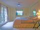 Bright main bedroom with double doors, built-in cabinetry, and a ceiling fan at 263 Overbrook E St, Largo, FL 33770