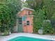 Small shed near the pool in a lush garden at 263 Overbrook E St, Largo, FL 33770