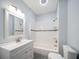 Updated bathroom with white vanity, tub, and tile flooring at 2758 3Rd S Ave, St Petersburg, FL 33712