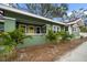 Green house with landscaping and palm trees at 2758 3Rd S Ave, St Petersburg, FL 33712