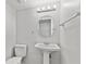 Simple bathroom with pedestal sink and a round mirror at 314 Barlow Ave # 73, Sarasota, FL 34232