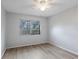 Bright bedroom with wood-look flooring and a window at 314 Barlow Ave # 73, Sarasota, FL 34232