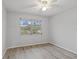 Bright bedroom with wood-look floors and a ceiling fan at 314 Barlow Ave # 73, Sarasota, FL 34232