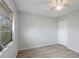 Spacious bedroom with wood-look flooring and window at 314 Barlow Ave # 73, Sarasota, FL 34232