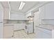 White kitchen with ample cabinet space and a cooktop at 314 Barlow Ave # 73, Sarasota, FL 34232