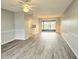 Spacious living room with wood-look floors and access to a patio at 314 Barlow Ave # 73, Sarasota, FL 34232