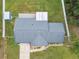 Aerial view of a single-Gathering home with a gray roof, shed, and fenced backyard at 3400 Lake Padgett Dr, Land O Lakes, FL 34639