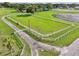 Aerial view of a large, grassy area enclosed by a white fence at 3400 Lake Padgett Dr, Land O Lakes, FL 34639