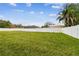 Large fenced backyard with grassy area and storage shed at 3400 Lake Padgett Dr, Land O Lakes, FL 34639