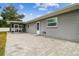 Grey house exterior and backyard with patio and screened porch at 3400 Lake Padgett Dr, Land O Lakes, FL 34639