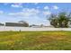 Large grassy backyard with a white vinyl fence at 3400 Lake Padgett Dr, Land O Lakes, FL 34639