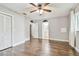 Bedroom with wood floors, ceiling fan and window at 3400 Lake Padgett Dr, Land O Lakes, FL 34639