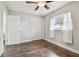 Bright bedroom with wood-look floors and ceiling fan at 3400 Lake Padgett Dr, Land O Lakes, FL 34639