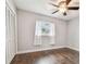 Spacious bedroom with wood-look floors and ceiling fan at 3400 Lake Padgett Dr, Land O Lakes, FL 34639