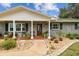 Inviting front entrance with a wood door, brick facade, and landscaping at 3400 Lake Padgett Dr, Land O Lakes, FL 34639