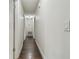 Clean hallway with dark hardwood floors and white walls at 3400 Lake Padgett Dr, Land O Lakes, FL 34639