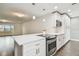 Modern kitchen with white cabinets, quartz countertops, and stainless steel appliances at 3400 Lake Padgett Dr, Land O Lakes, FL 34639