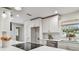 White kitchen with stainless steel appliances and subway tile backsplash at 3400 Lake Padgett Dr, Land O Lakes, FL 34639