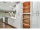 Open pantry with shelving in a bright white kitchen at 3400 Lake Padgett Dr, Land O Lakes, FL 34639