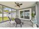 Cozy screened porch with patio furniture and sliding glass doors at 3400 Lake Padgett Dr, Land O Lakes, FL 34639