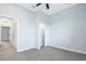 Bedroom with carpet flooring, ceiling fan and door to hallway at 3421 W Horatio St # 109, Tampa, FL 33609