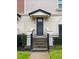 Front view of a townhome with a dark gray door and black fence at 3421 W Horatio St # 109, Tampa, FL 33609