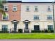 Front view of two townhouses with gray doors and black fence at 3421 W Horatio St # 109, Tampa, FL 33609