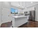 Modern kitchen with white cabinets, island, and stainless steel appliances at 3421 W Horatio St # 109, Tampa, FL 33609